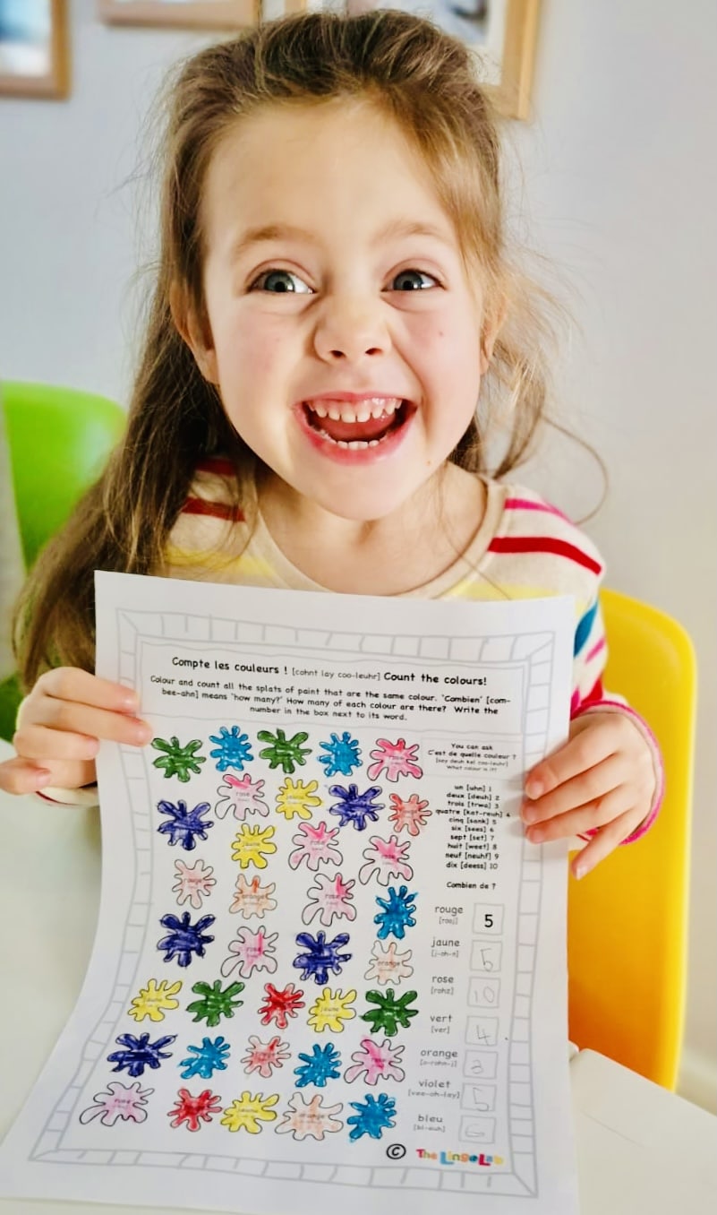 A pupil holding multi colour splat worksheet